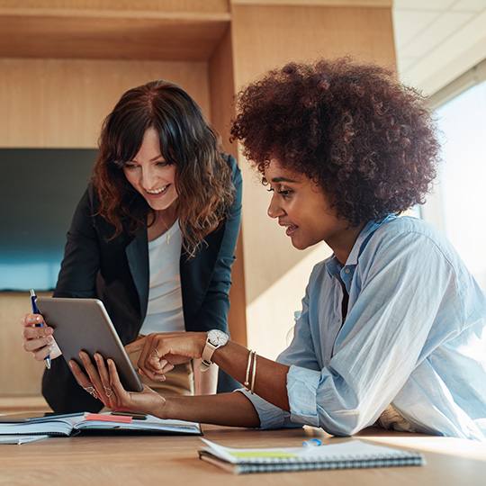 two women at a table working