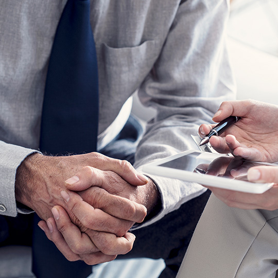 close up of hands clasped in a meeting