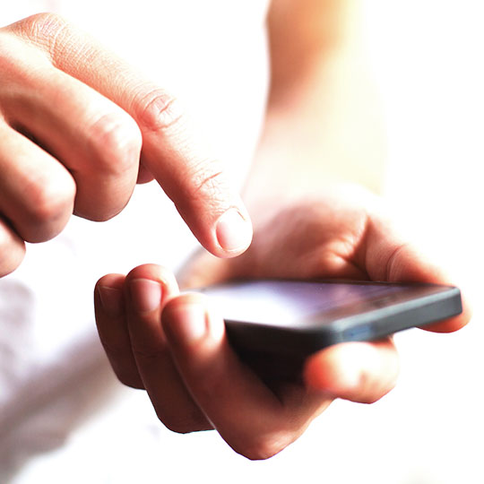 close up of a hand typing on a smartphone